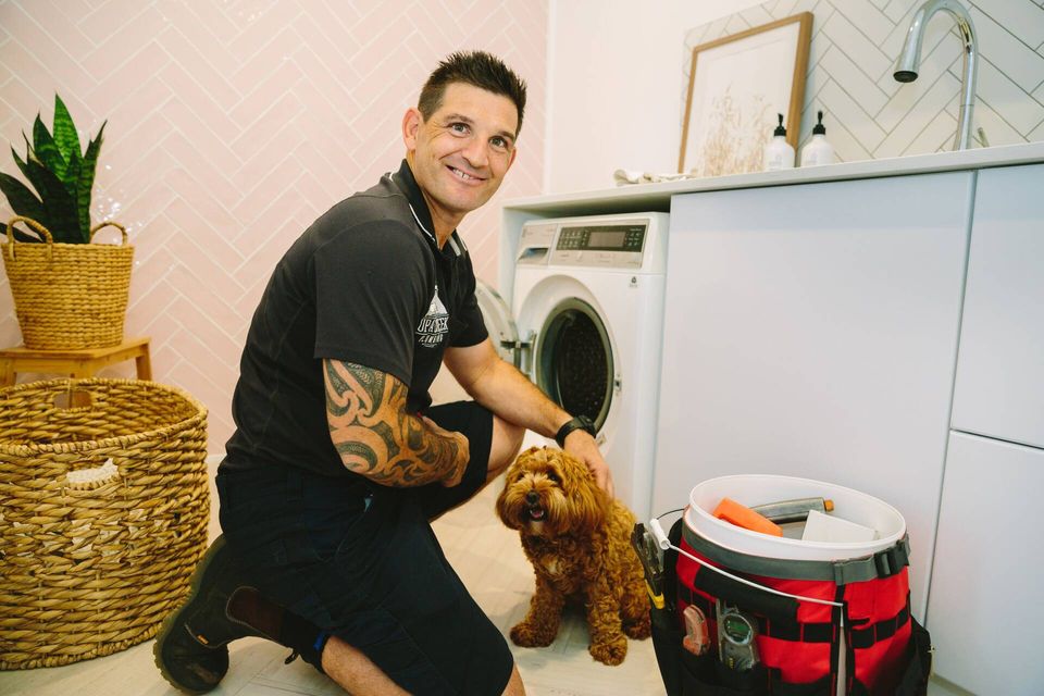 Friendly plumber with dog - family business values